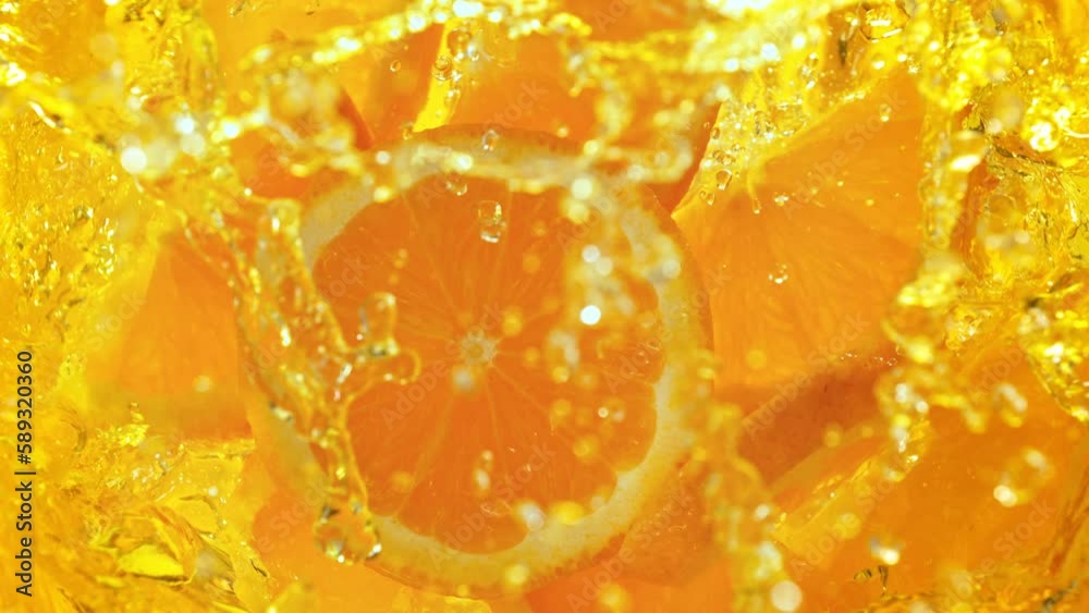 Super Slow Motion Shot of Fresh Orange Slices Falling into Lemonade Whirl at 1000 fps. Super Slow Motion Shot of Fresh Orange Slices Falling into Lemonade Whirl at 1000 fps.