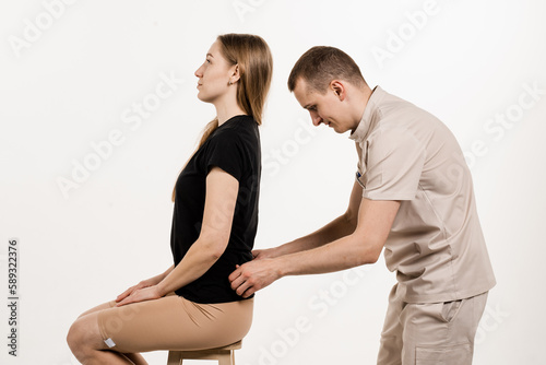 Manual therapy at physiotherapist or chiropractor. Orthopedist examining female neck and head. Manual correction of the ridge and cervical region. Rehabilitation therapy on white background.