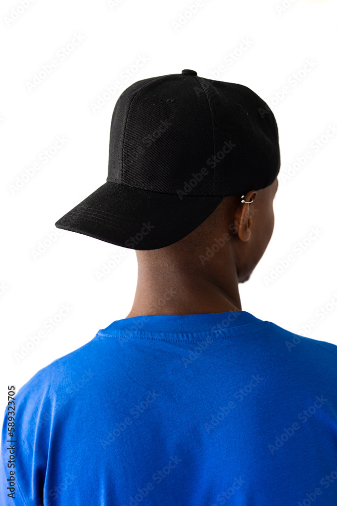 African american man wearing blue t-shirt and black cap with copy space on white background African american man wearing blue t-shirt and black cap with copy space on white background