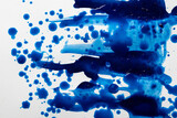 Close up of blue paint shapes on white background with copy space