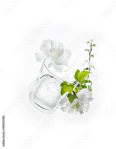Transparent cup with flowers and green shoot