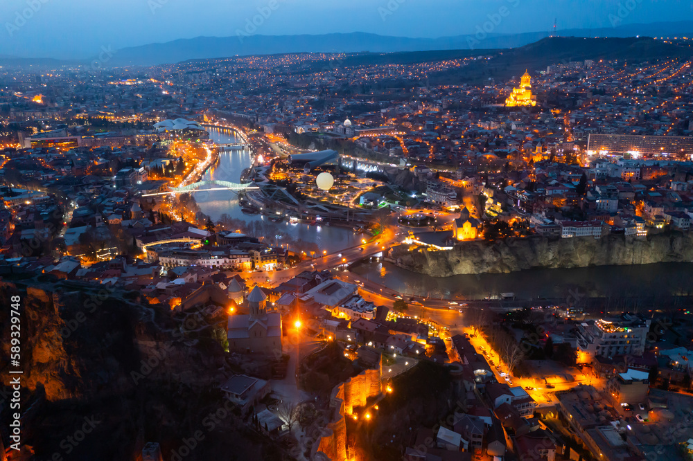 Night aerial view of Tbilisi city with Kura river and Europe square in the spring, Georgia