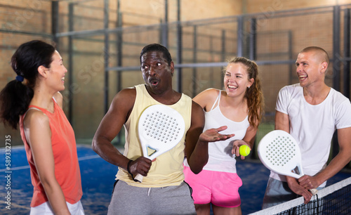 Two happy couples after playing padel on the tennis court
