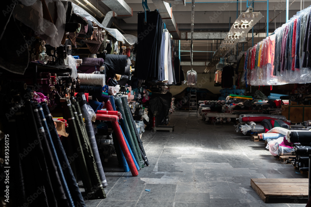 Obraz premium Interior of an industrial warehouse with fabric rolls samples. Small business textile colorful warehouse.