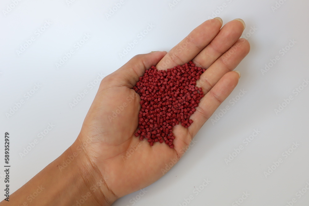 Red plastic pellets, rubber granules on a white background
Red plastic pellets, rubber granules on a white background