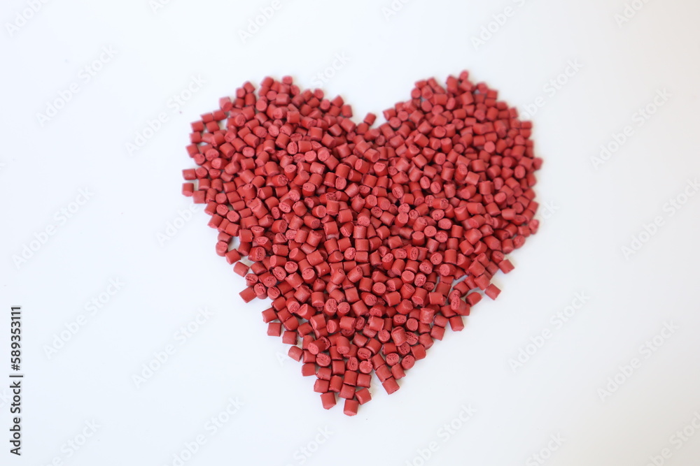 Red plastic pellets, rubber granules on a white background


