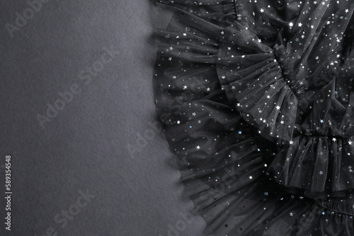 Beautiful black tulle fabric on grey background, top view. Space for text