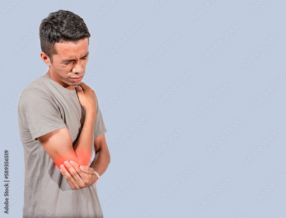 Person with elbow pain, concept of a people with elbow pain from rheumatism, shirtless man massaging sore elbow, man with elbow cramp Person with elbow pain, concept of a people with elbow pain from rheumatism, shirtless man massaging sore elbow, man with elbow cramp