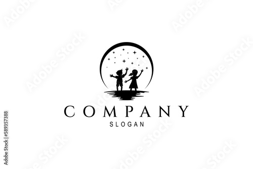silhouette logo of boy and girl playing under the stars at night decorated with full moon