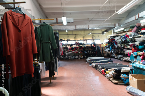 Interior of an industrial warehouse with fabric rolls samples. Small business textile colorful warehouse.