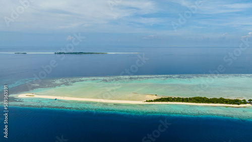 Top view of sandy tropical island with a beautiful beach surrounded by a coral reef.Timba Timba islet. Tun Sakaran Marine Park. Borneo, Sabah, Malaysia.