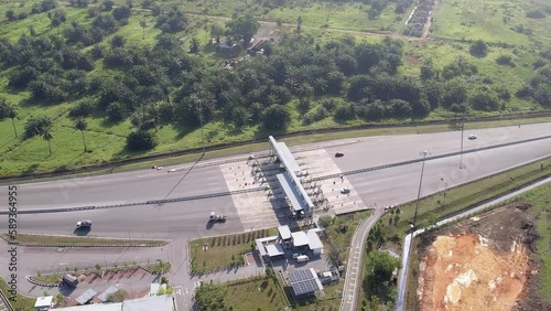 Selangor, Malaysia - Wed 22, 2023 Aerial cinematic circle view of the Kapar Toll Plaza in Klang near the plantations photo