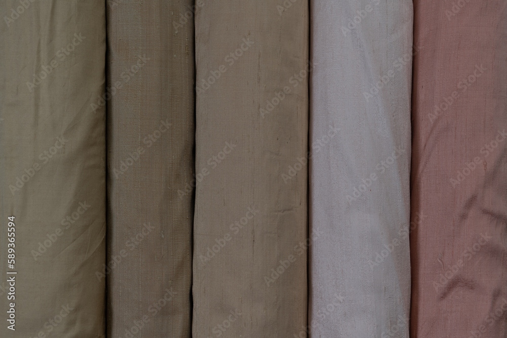 Collection of fashionable fabrics. Samples of different natural fabrics for sewing a fashion collection of clothes. Large selection of fabrics in the store or tailor warehouse. Collection of fashionable fabrics. Samples of different natural fabrics for sewing a fashion collection of clothes. Large selection of fabrics in the store or tailor warehouse.