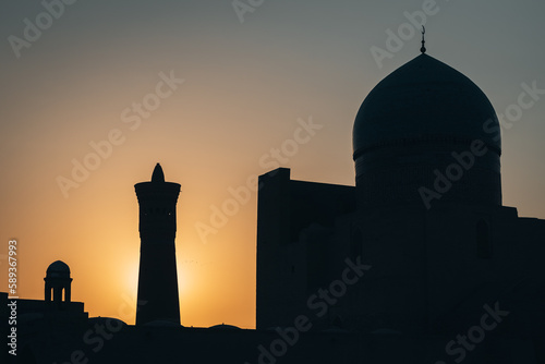 Sunrise silhouette view of minaret Kalyan and a mosque in Bukhara, Uzbekistan
