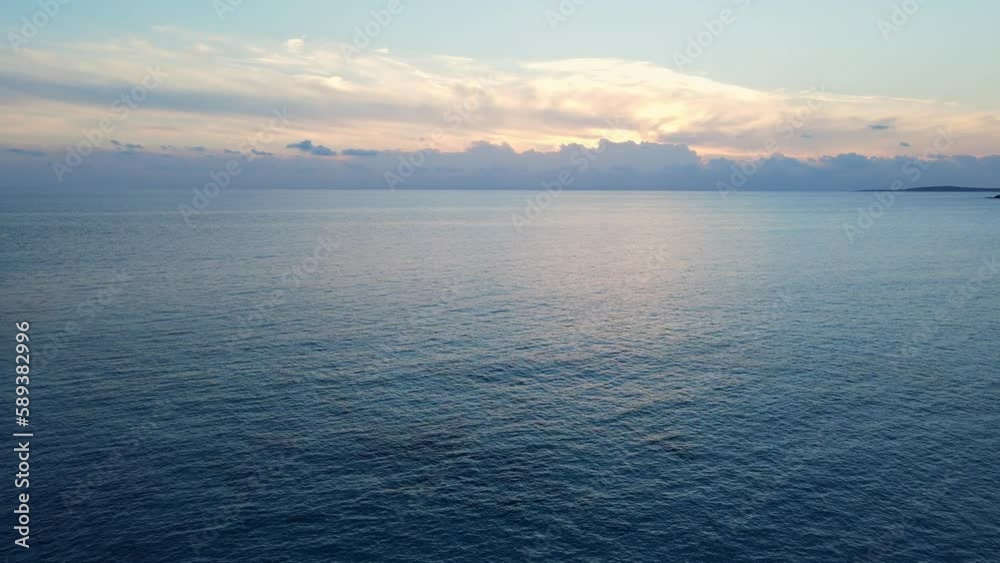 Cinematic seascape with sunset behind the clouds along the coastline of Spain. Cinematic seascape with sunset behind the clouds along the coastline of Spain.