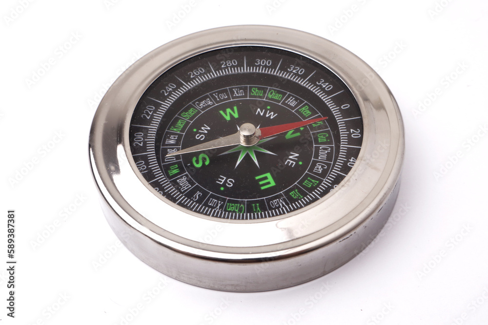 Magnetic silver metal compass on white background Magnetic silver metal compass on white background
