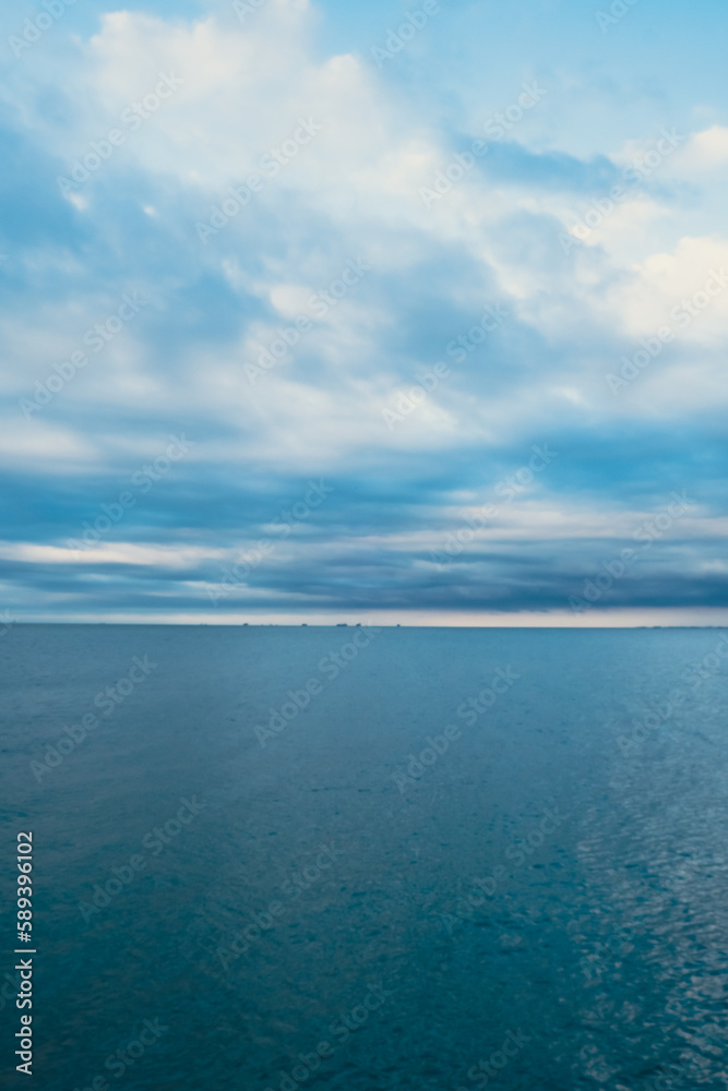 Fototapeta premium Vivid colourful clouds Dramatic Sky At Sunrise or Sunset. Blue sky with beautiful clouds in background. Gradient cold to warm. Defocused abstract background Natural texture Wallpaper. Amazing golden