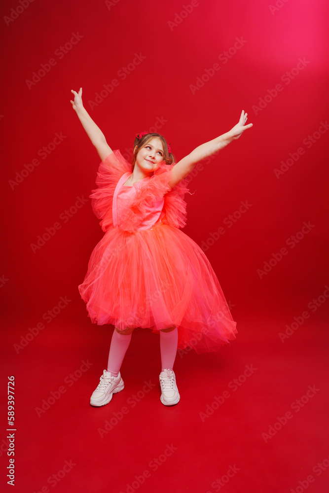 Naklejka premium a beautiful teenage girl with ponytails in a pink elegant dress. 