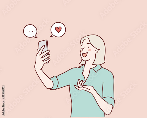 happy young woman look at the smartphone and smile. Hand drawn style vector design illustrations.