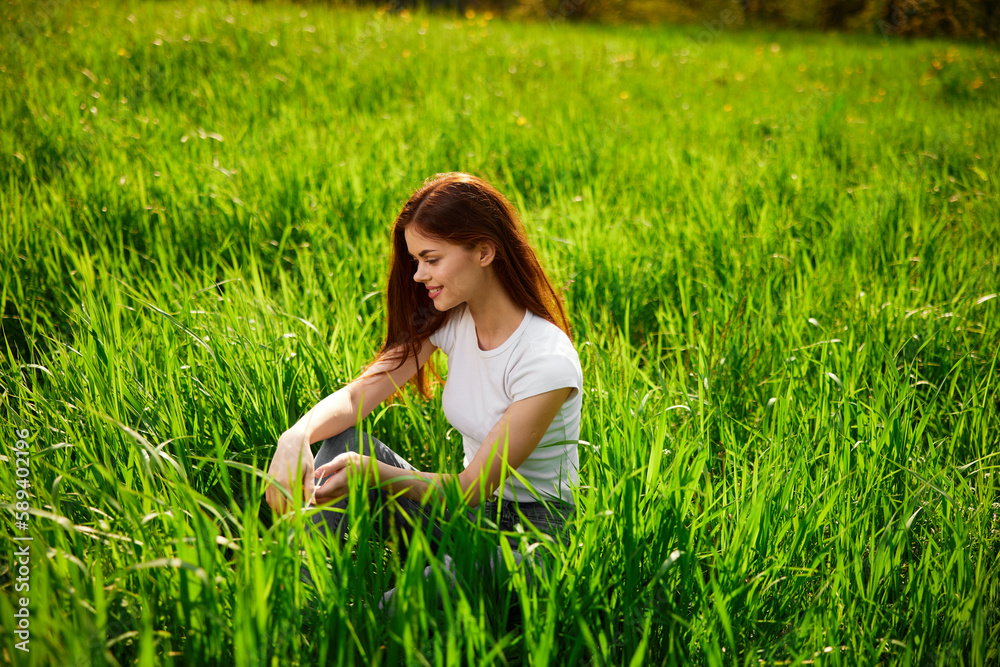 playful, happy, free woman sitting in tall grass playful, happy, free woman sitting in tall grass