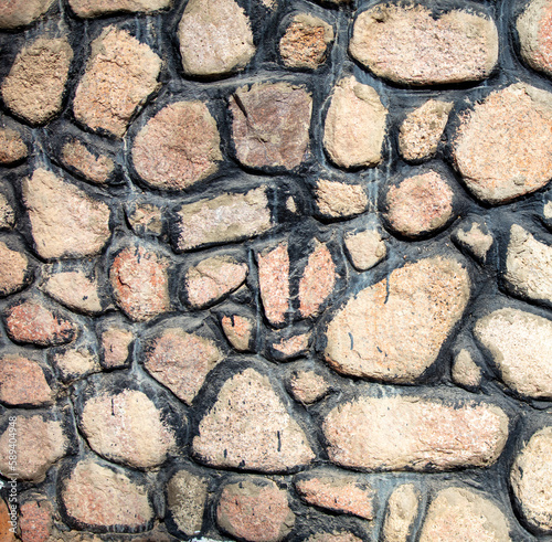 A wall of laid out stones as a background.