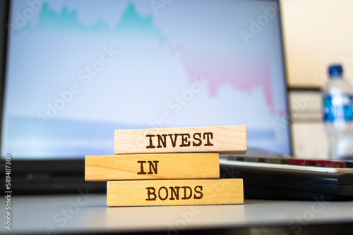 Wooden blocks with words 'INVEST IN BONDS'. Business concept photo