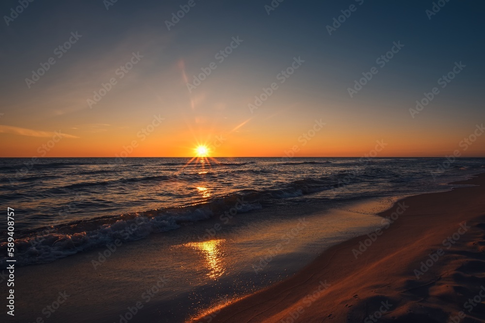 Beautiful colorful landscape on the beach by the sea. Sunrise over the Baltic Sea in Jastarnia, Poland. Beautiful colorful landscape on the beach by the sea. Sunrise over the Baltic Sea in Jastarnia, Poland.