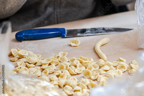 Fresh orecchiette or orecchietta, made with durum wheat and water, handmade pasta typical of Puglia or Apulia, a region of Southern Italy, close up photo