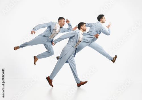 Serious men wearing elegant suit hurry up over white background. Going on important business