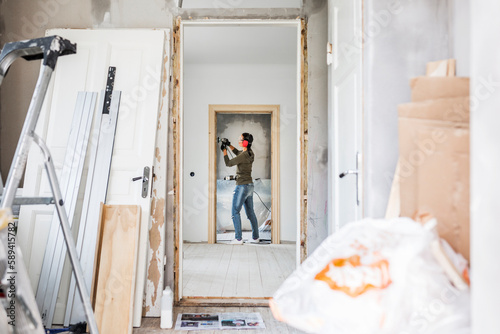 Woman polishing door frame during renovation