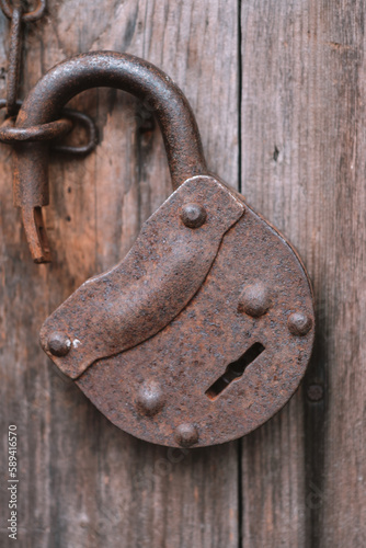 old rusty lock on a wooden door
