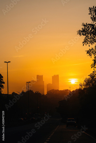 Golden sunrise near the skyscraper building. © ellinnur