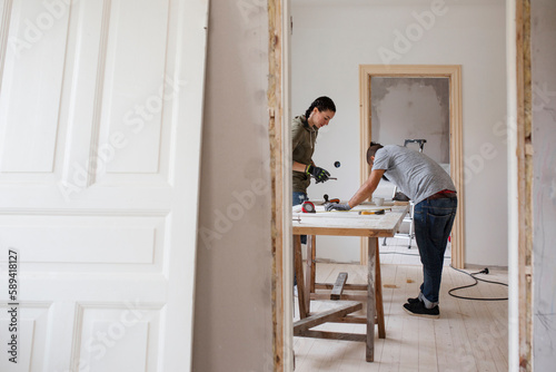 Couple working at workbench during renovation