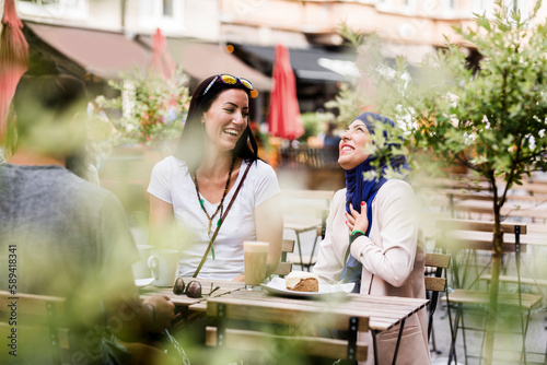 Group of people sitting at outdoor cafe table