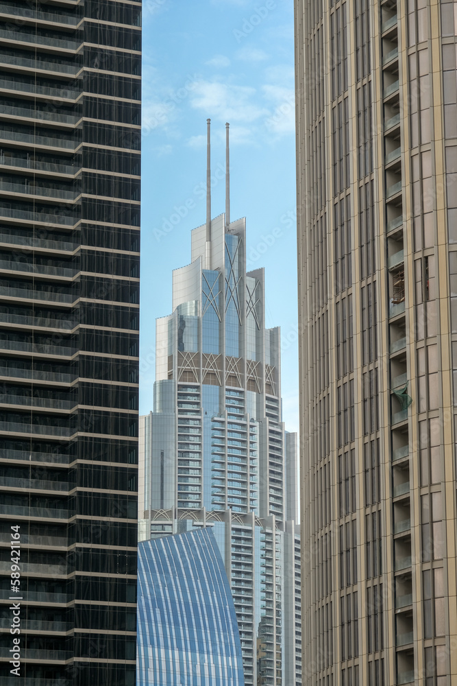 Futuristic and modern commercial and residential highrise tower skyscraper architecture with glass facades and clean lines in downtown Dubai, United Arab Emirates for millionaires and high society