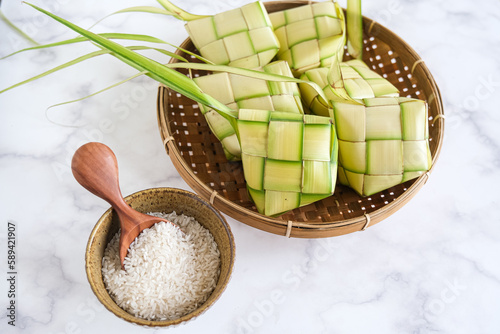 ketupat or rice dumpling is alocal delicacy duting the festive season, ramadhan. ketupat, a natural rice casing made from young coconut leaves for cooking rice photo