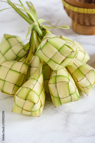 ketupat or rice dumpling is alocal delicacy duting the festive season, ramadhan. ketupat, a natural rice casing made from young coconut leaves for cooking rice photo