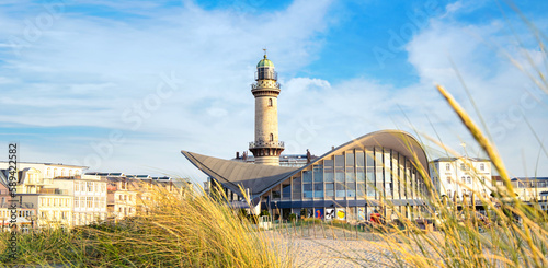 Obraz na płótnie Banner with lighthouse in Warnemunde Rostock. Germany baltic sea vacation and travel destinations. Copy space for text w salonie