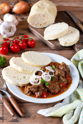 Czech traditional recipe for goulash with homemade dumpligs, served in simple rustic style