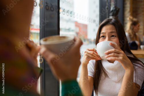 Two women drinking coffee in cafe