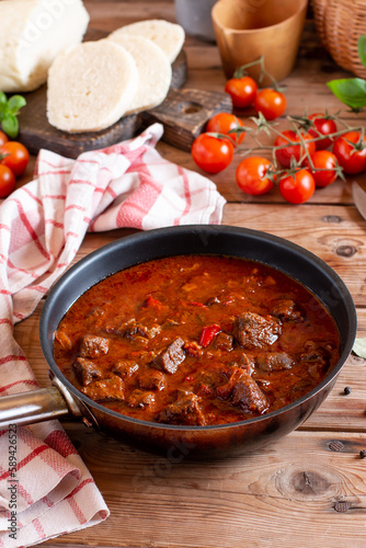 Traditional czech goulash in a frying pan on table