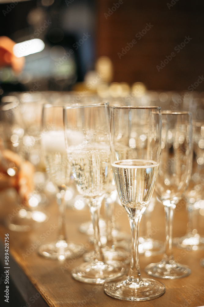 Fototapeta premium lots of champagne glasses on the wooden bar counter