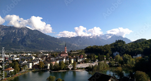 overlooking a lake and a small village in switzerland with the alps in background