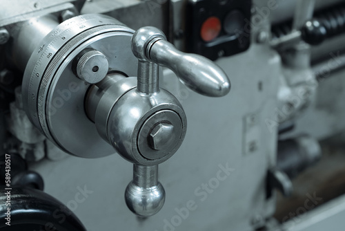 This is part of close-up metal lathe. Industrial equipment for metal processing. Milling machine handle.. © SerPak