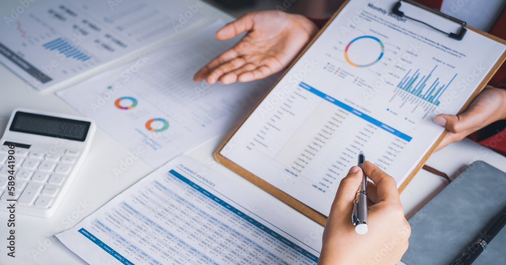 Close up businessman hand using calculator and writing make note with calculate about finance accounting.finance accounting concept Close up businessman hand using calculator and writing make note with calculate about finance accounting.finance accounting concept