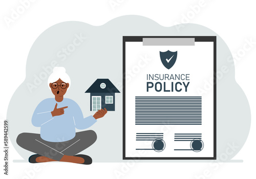 A woman holds in his hands at home next to a large insurance contract. Home and real estate insurance concept.