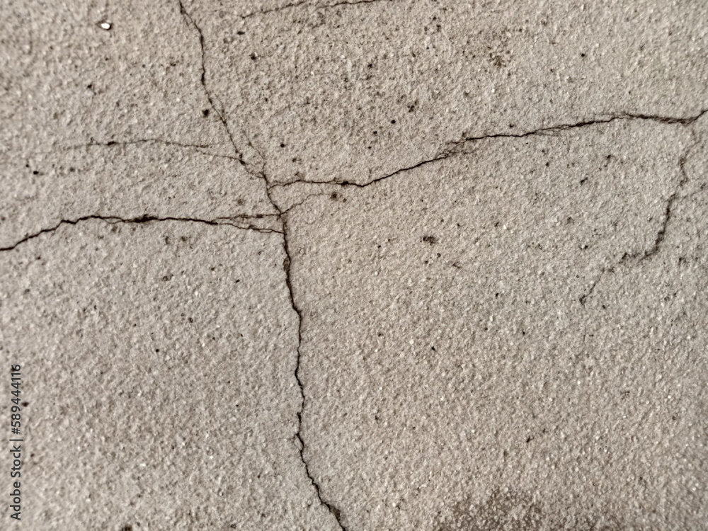 The surface of the old cement floor has holes and various cracks. The surface of the old cement floor has holes and various cracks.