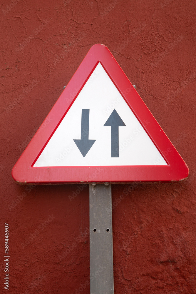 Two Way Traffic Sign on Red Wall Two Way Traffic Sign on Red Wall