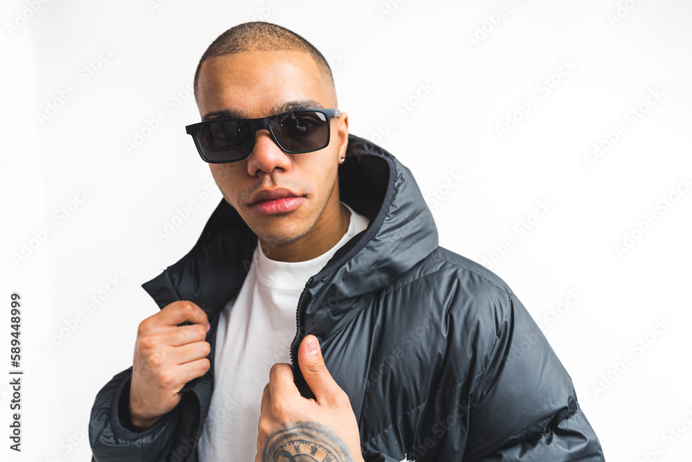 Portrait of a male model in winter jacket and dark sunglasses on white background . High quality photo Portrait of a male model in winter jacket and dark sunglasses on white background . High quality photo