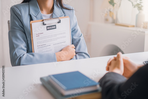 Young woman submit resume employer to review job application. Concept presents ability for the company to agree with position of the job.